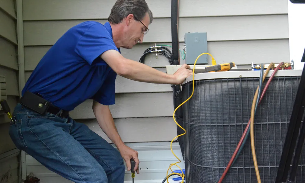 Professional air conditioner technician servicing an outdoor unit
