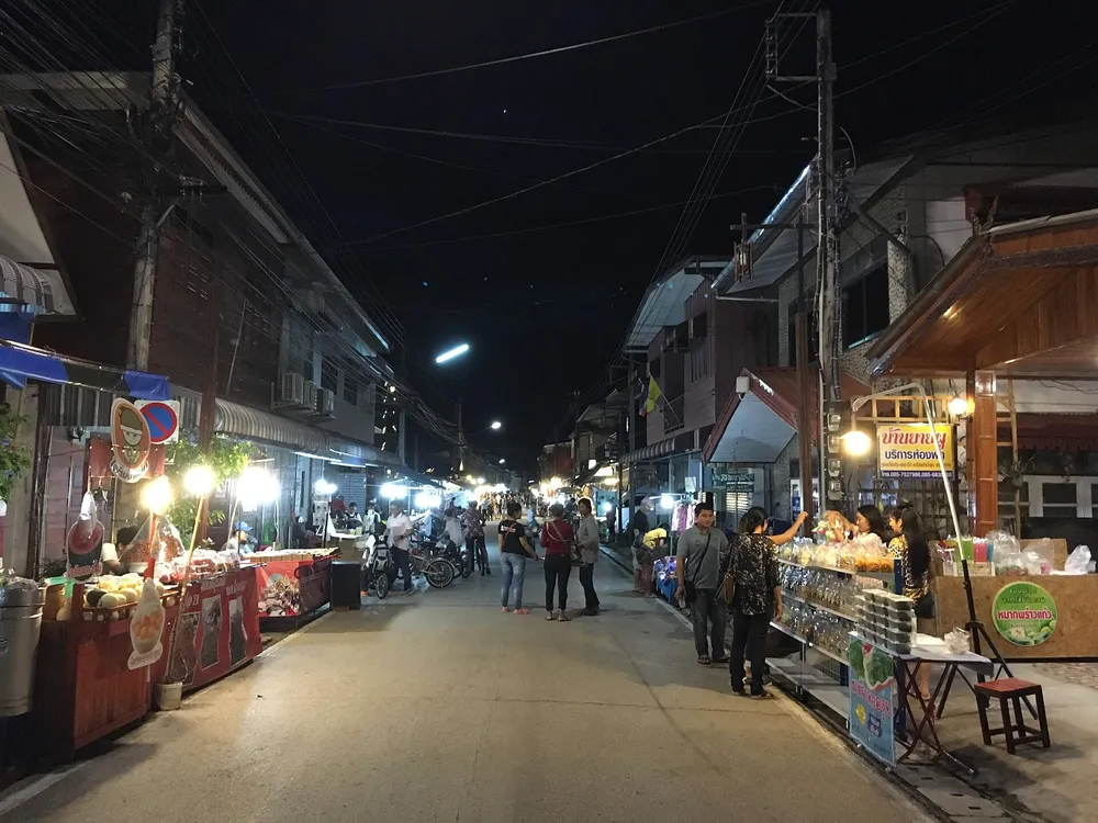 ถนนคนเดินเชียงคานยามค่ำคืน ร้านค้าและนักท่องเที่ยวเดินเล่นสองฝั่งถนนไม้เก่า
