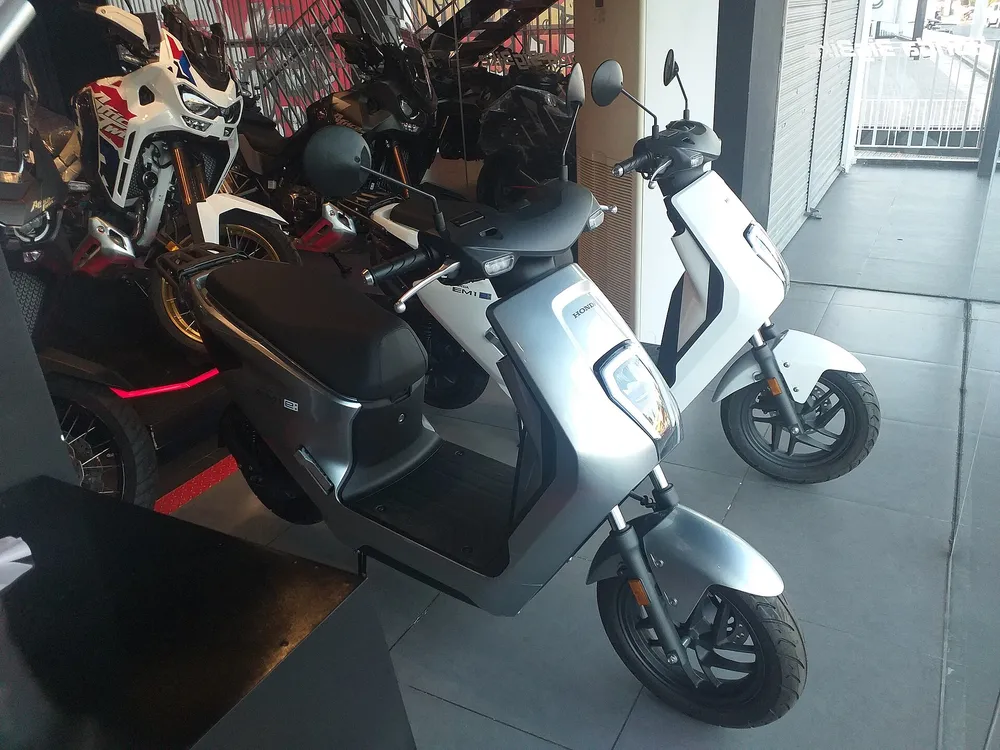 Honda EM1 e: electric motorcycle on display in a showroom