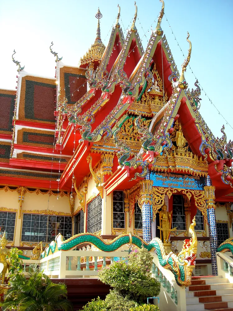 Colorful Thai Buddhist temple on Koh Samui with ornate gold-and-red roof