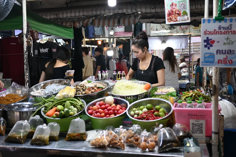 A Thai shop displaying a sign for a government co-payment program with a QR code