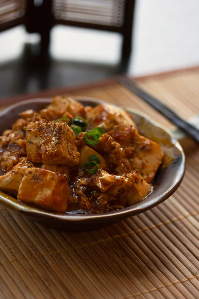 Stir-fried tofu in sauce, a key protein source during the Vegetarian Festival