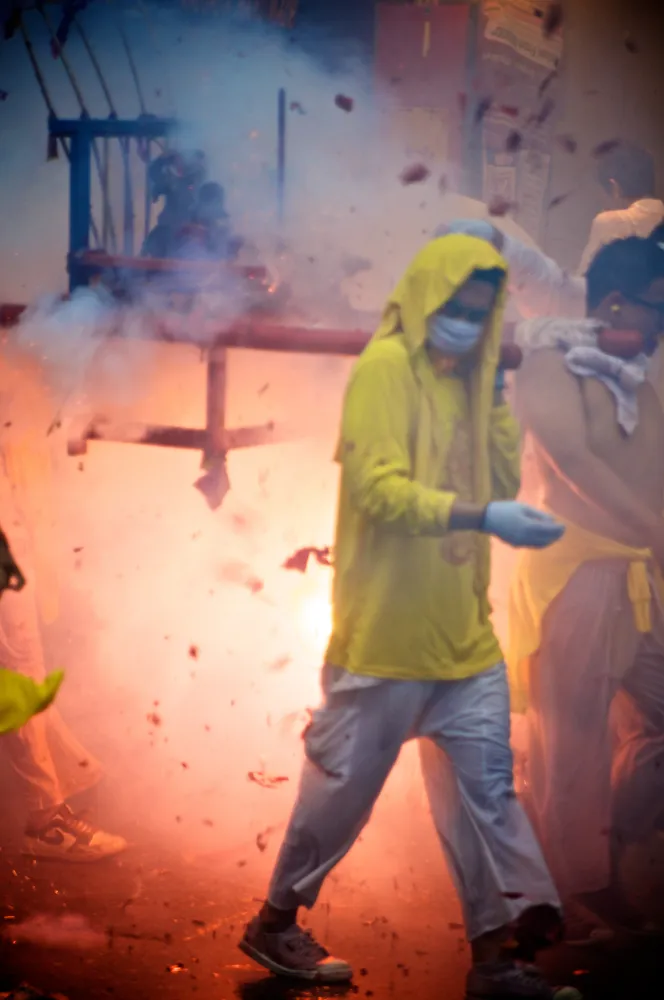 Smoke and firecrackers during a Phuket Vegetarian Festival procession