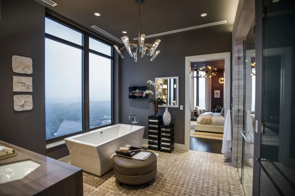 A luxury bathroom with a bathtub — homes with several hot-water points may justify a multi-point system or heat pump