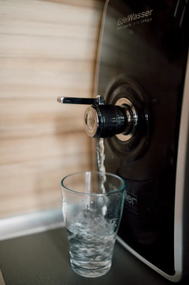 Home water dispenser dispensing clean water into a glass