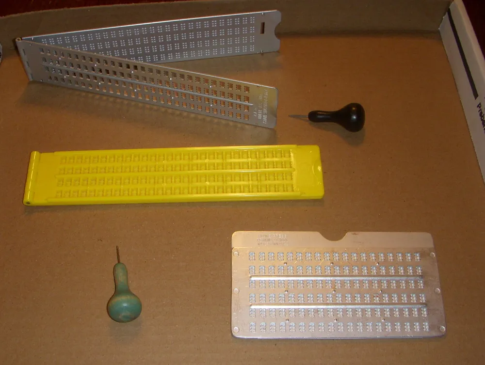 A braille slate and stylus used for writing braille