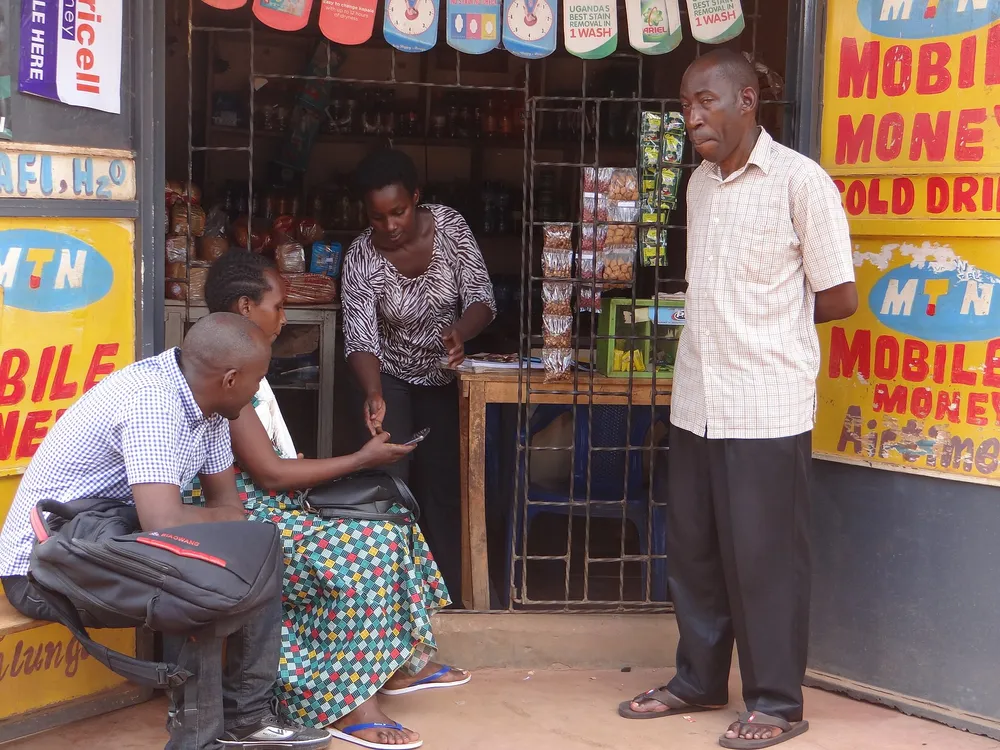 People at a mobile-money agent shop, where customers send and receive money by phone