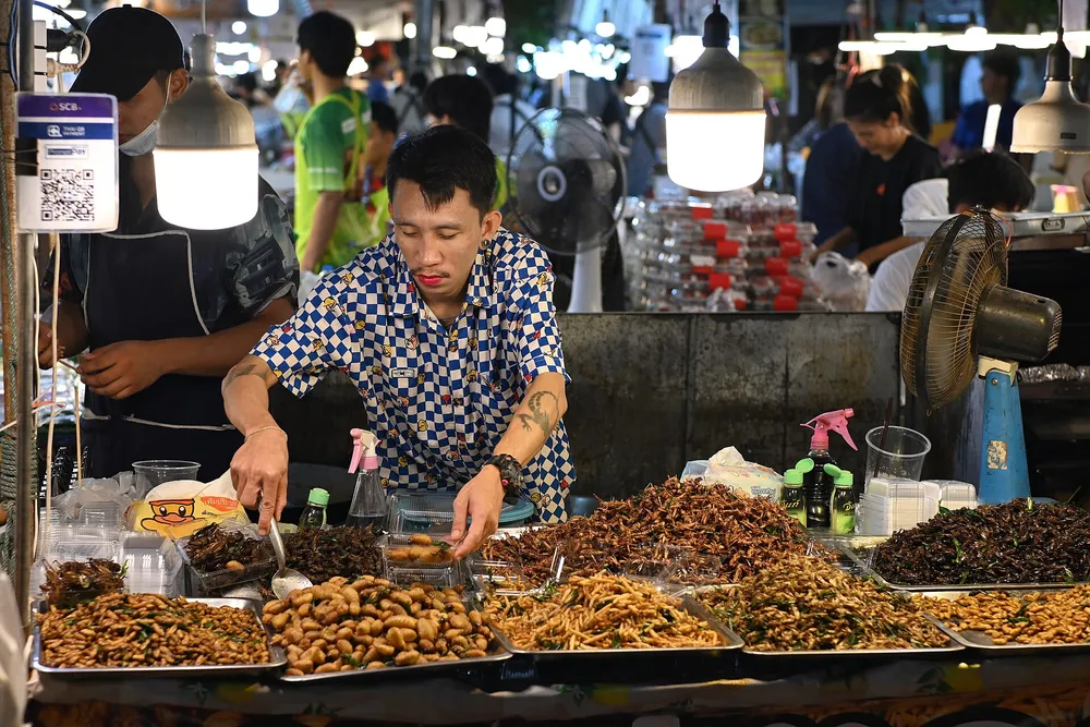 A street market where vendors accept digital QR payments alongside cash