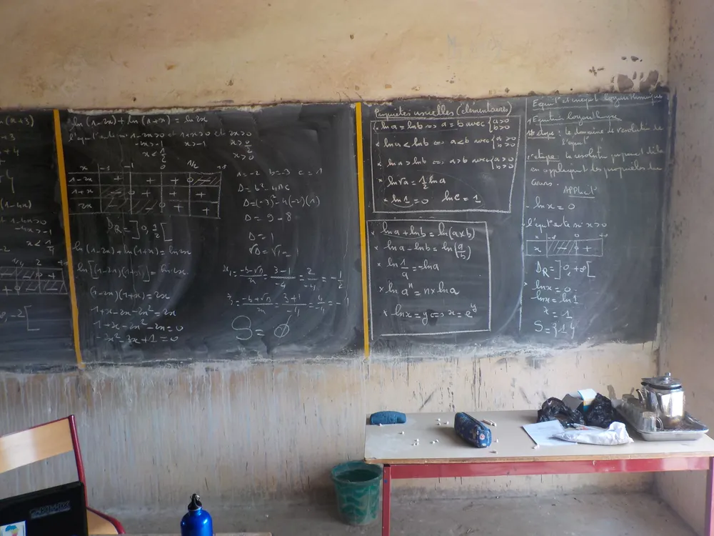 A blackboard covered in handwritten mathematical equations