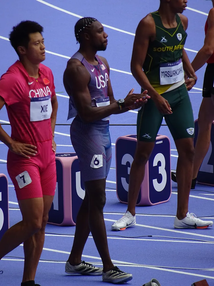 Xie Zhenye of China (left), the Asian 200m record holder at 19.88 seconds since 2019 — a time Boonson has now matched