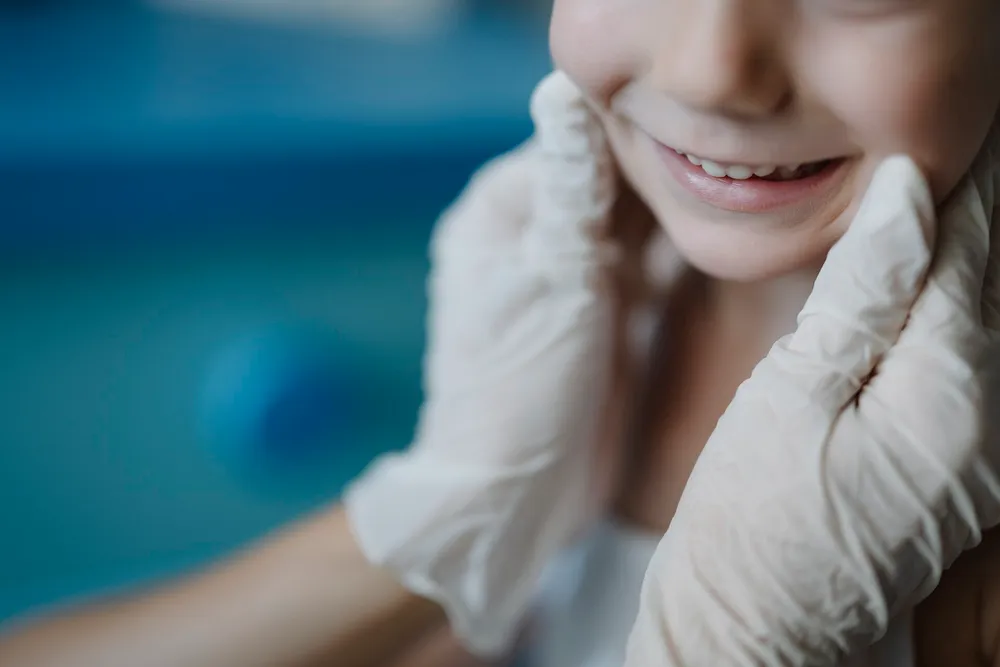 A child smiling during a dental checkup