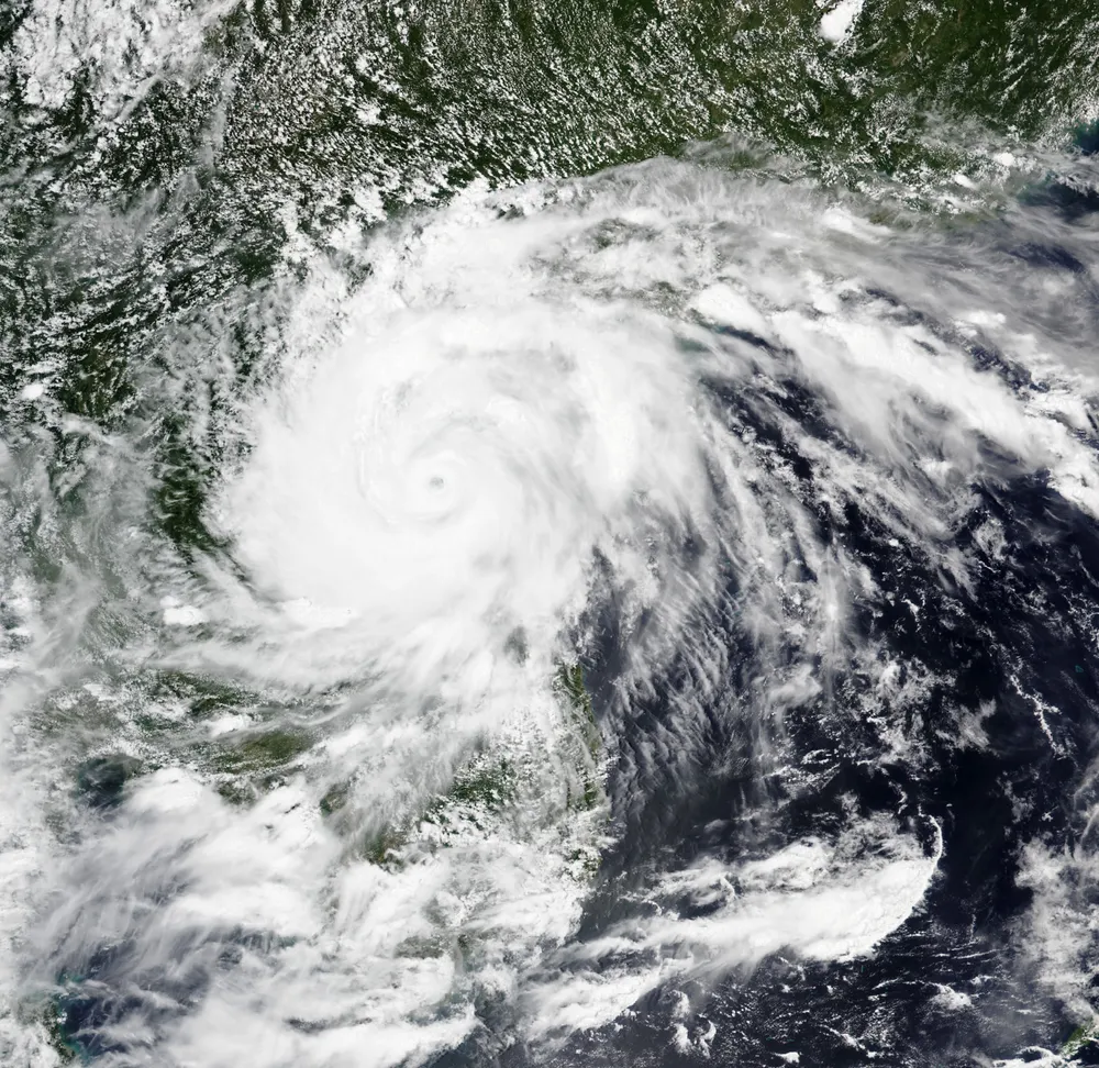 Satellite image of a tropical storm system over Southeast Asia — Severe Tropical Storm Noul in the South China Sea is boosting moisture across the southwest monsoon over Thailand (illustrative)