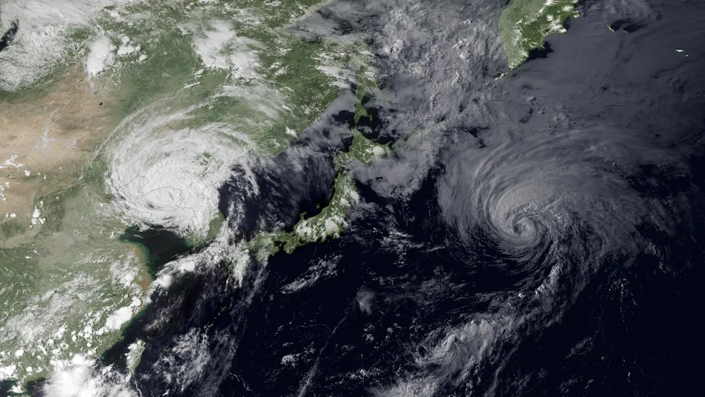 Satellite image showing two simultaneous typhoon systems over East Asia — illustrating the high frequency of Pacific typhoons in the 2026 season — NASA/NOAA, Public Domain