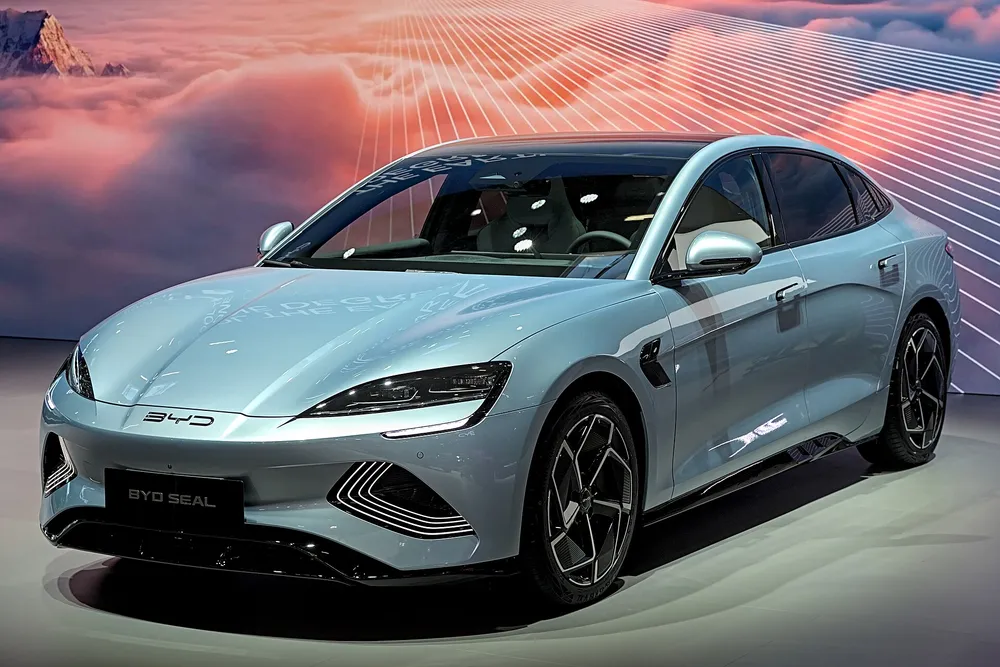 BYD Seal electric sedan at an auto show — BYD is among the world's best-selling EV brands and has manufacturing facilities in Thailand serving the ASEAN market, making this global EV shift directly relevant to Thai consumers and industry